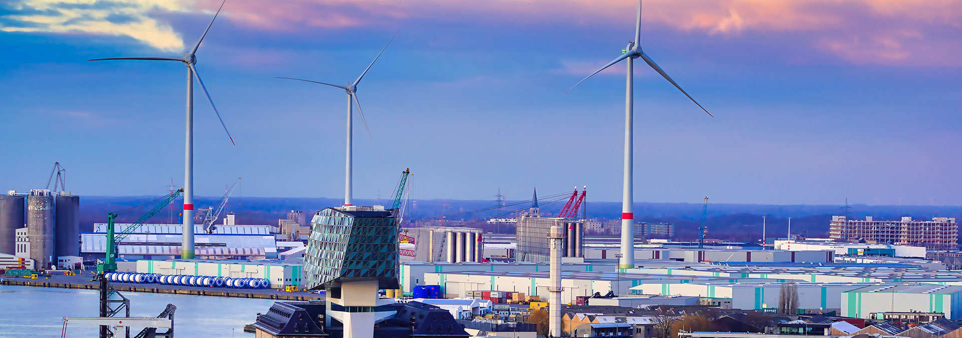 A sunset sky with wind turbines over the port of Antwerp